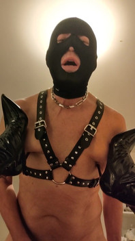 Mistress Digs the Heels of Her Boots Into Her Slave