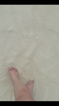 Running My Bare Feet on the White Beach Sand by the Ocean