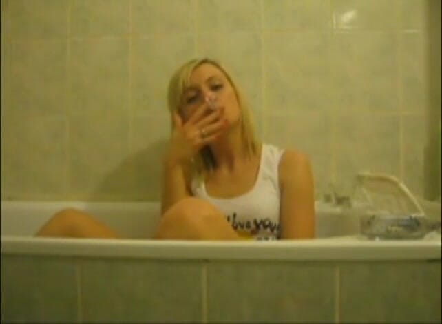 Femdom Austria: Blonde bitch in the bathtub smoking cigarettes