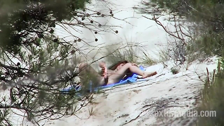 Sextermedia by Pete: Redhead beauty dildoing pussy on the sandy beach