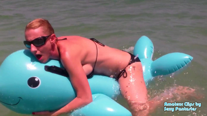 Brittany Lynn: Humping blue inflatable toy in the water at a beach...
