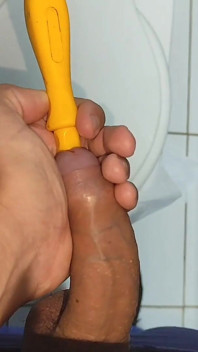 Young Straight Man Inserting the Tool Through the Glans.