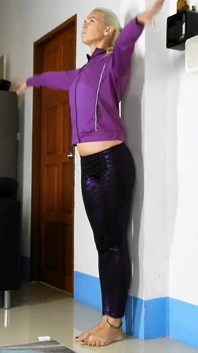 Sensual Wall Stretching in Shiny Purple Leggings