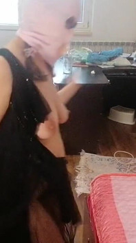 O femeie amatoare se distrează încercând hainele și tăindu-le