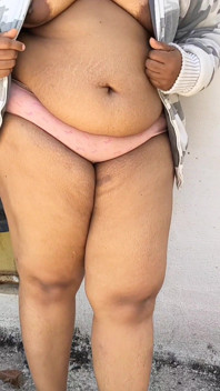 India Curvy Girl in White Jacket Strips for the Camera