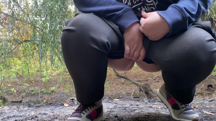 Elena: MILF dressed in pants pissing outdoors