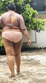 A Full-figured Woman in a White Skirt and Pink Top Strips Down and Walks Nude Outside