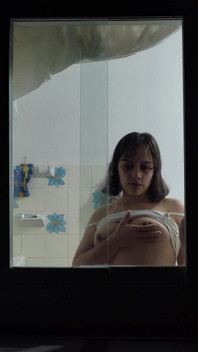 Latina Girl Filmed Through a Window