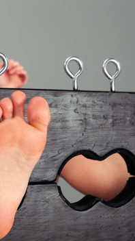 Maya Mineo with Her Feet in Stocks While Suzuka Kawai Stimulates Them with Various Objects