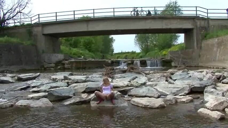 Femdom Austria: Blonde pissing outside in a river
