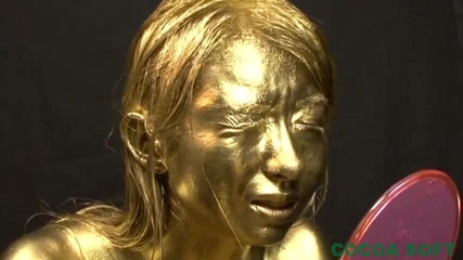 Cocoa Soft: A beautiful woman is exercising with full body gold