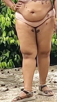A Full-figured Woman in a White Skirt and Pink Top Strips Down and Walks Nude Outside
