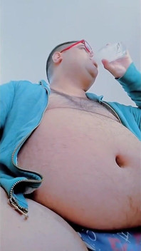 Fat Man Having Lunch and Touching His Belly