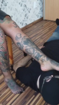 Blonde tattooed lady and her foot slave
