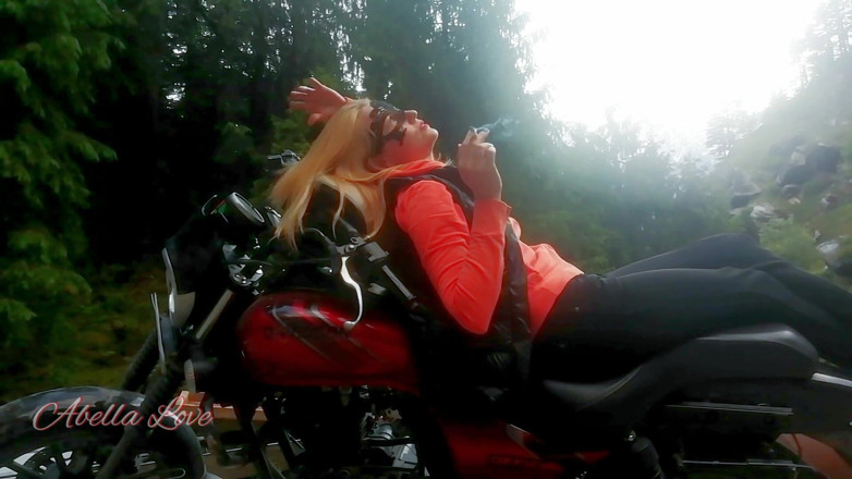 Abella Love: Red lips blonde smoking sensually on Rasta bike outdoor