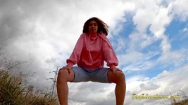 Running outdoors and pee with her legs wide opened outdoor