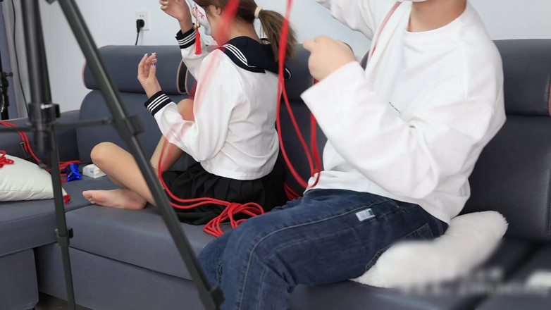 Asian bondage: The Barefoot Girl Is Bound with Red Ropes, Tickling Her...