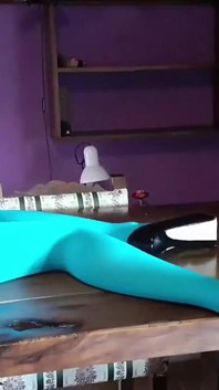 MILF with Beautiful Legs in Pantyhose and Heels Lying on the Table