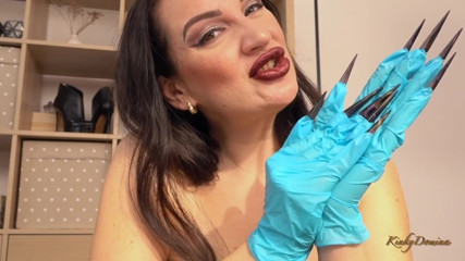 KinkyDomina: Kinkydomina Christine puts on a pair of latex gloves with...