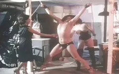 Two masters tie up skinny slave.