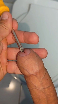 Young Straight Man Inserting the Tool Through the Glans.