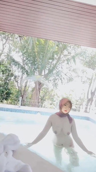 Hijab-wearing Woman Bathes Naked in an Open Swimming Pool