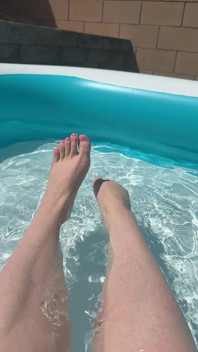 Gioca da sola con i piedi in piscina