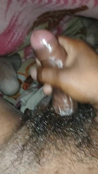 Big Boss massaging penis oil under the blanket