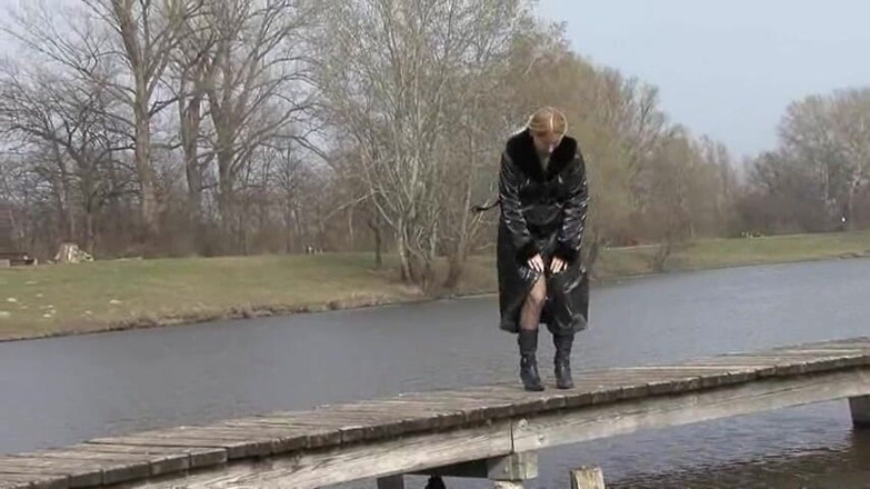 Femdom Austria: Bitch in leather pissing on a pier