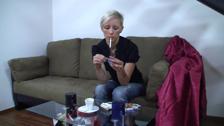 Smoke it bitch: Blonde young chick with piercing between her eyebrows smokes a...