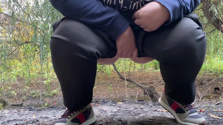 Elena: MILF dressed in pants pissing outdoors
