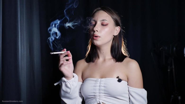 Russian Smokers: Elegant Brunette Smoking Cigarette in Dark Studio Scene