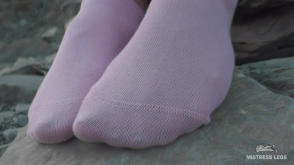 Mistress Legs: Sexy feet in pink ankle socks on the seashore