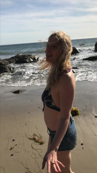 Model blows on the beach