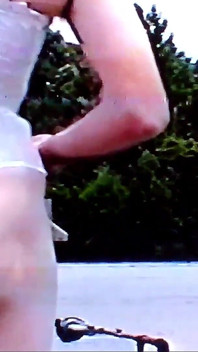 Crossdresser Riding a Giant Dildo on a Roof Top