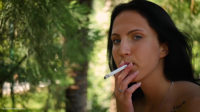 Russian Smokers: Seductive Russian Beauty Smoking Slim Cigarette Outdoors