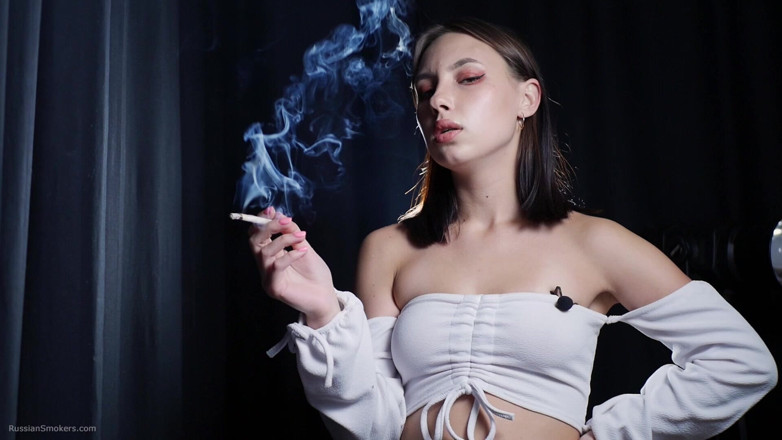 Russian Smokers: Elegant Brunette Smoking Cigarette in Dark Studio Scene