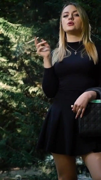 Hot Blonde Babe Smoking One Black Cigarettes in Nature
