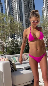 Monika Fox Poses in Pink Bikini and Swims in Pool Surrounded by Skyscrapers